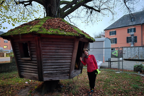 Moss-covered cabin and a happy biker