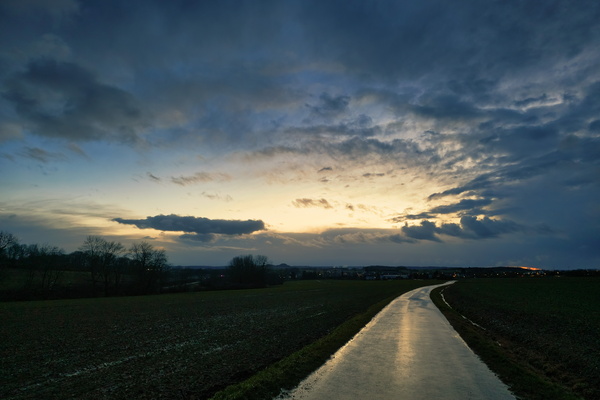The stormy heavens opening above a calm path.